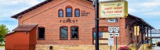 Front of library, an old brick train depot